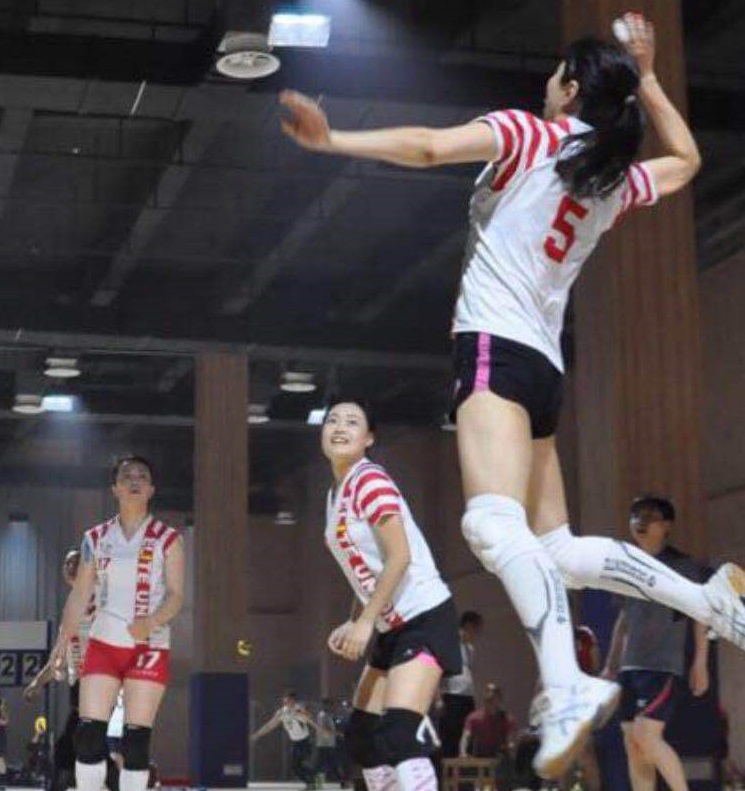 Red White Volleyball sublimation uniform in play women jumping